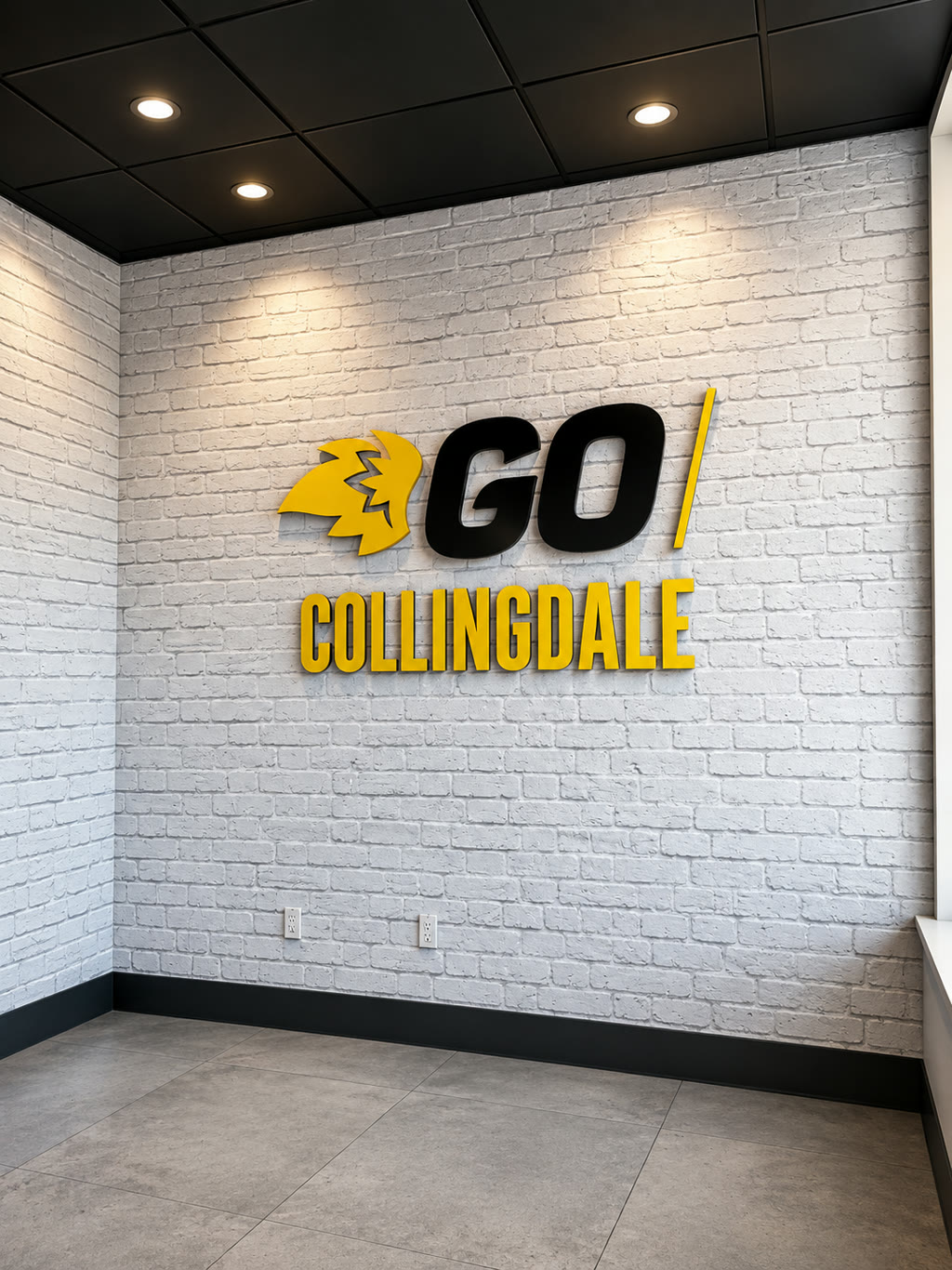 Commercial wallcovering installation by RGT Wallpaper — white brick textured wall with dimensional GO Collingdale branding